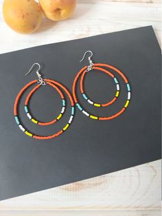 Large double beaded hoop earrings. Handmade item. Dangles down about 3.1 inches. This item is a pair of double hoop earrings. Earrings made of metal hoops with high-quality Toho seed beads.  The bead colors are turquoise, black, orange, yellow and white. Silver-plated findings earring hooks. If you have any questions about this pair of earrings, please contact me. Seed Bead Double Hoop Earrings, Southwestern Style Beaded Dangle Hoop Earrings, Southwestern Dangle Hoop Earrings With Ear Wire, Native American Inspired Earrings, Southwestern Colors, Feminine Earrings, Homemade Earrings, Turquoise Hoop Earrings, Turquoise Hoops