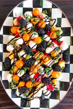 a white plate topped with fruit covered in chocolate sauce