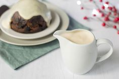 a cup of coffee sitting next to a plate with a pastry on top of it