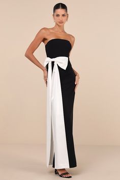 When you walk in wearing the Lulus Marvelous Vision Black Strapless Bow Column Maxi Dress, everyone will see you for what you truly areâ€”a stylish and stunning wonder! Stretchy crepe knit shapes this glamorous dress that features a strapless, princess-seamed bodice (with hidden no-slip strips) and a straight neckline. The high, fitted waist tops a figure-skimming column skirt that falls to an elegant maxi hem with a convenient kick pleat at the back. An oversized white bow with extra long tails Bow Dresses Women Long, Black Dress With White Bow, Black And White Ball Gown, Long Dress With Bow, Fall Formal Dresses, Gala Fundraiser, Bow Gown, Black Wedding Guest Dresses, Dress With A Bow