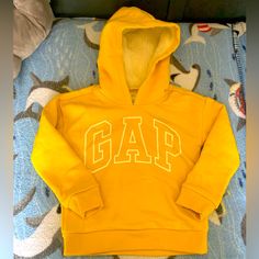 About This Item The Classic Gap Look: Give Your Little One The Gap Look With This Cute And Cozy Hoodie, An Essential In Any Child’s Wardrobe Super Soft Sherpa Lining: This Pullover Sweatshirt Keeps Your Kid Warm And Comfortable With Its Soft Sherpa Lining Machine Washable: Easy To Care For, This Sweatshirt Can Be Washed With Like Colors On The Gentle Cycle Gap For The Whole Family: Our Baby Apparel And Kids Clothing Is Designed To Be Inclusive With Fits And Styles For Little Ones Of All Ages Cheap Yellow Fleece Hoodie, Cheap Yellow Sweatshirt With Letter Print, Cheap Yellow Letter Print Sweatshirt, Cheap Yellow Hoodie With Letter Print, Fall Hooded Jacket, Kids Denim Jeans, Kids Blazers, Gap Hoodie, Yellow Hoodie