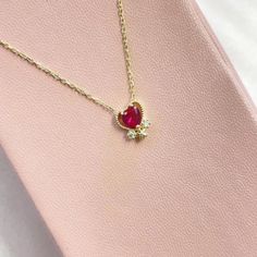 Introducing our stunning Gold Heart Garnet Gemstone Necklace, a timeless piece of jewelry that will elevate any outfit with its elegant and sophisticated design. Crafted from high-quality, this necklace features a delicate heart-shaped pendant that is embellished with a brilliant, deep red garnet gemstone. The warm tones of the gold perfectly complement the rich, vivid color of the gemstone, creating a beautiful contrast that is sure to catch the eye. Measuring 18 inches in length, the necklace