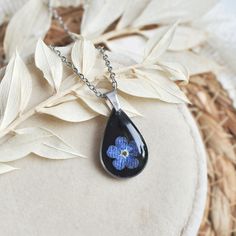 Teardrop black necklace for woman, unique resin jewelry, pendant with forget me not, botanical charm gift This is beautiful and elegant handmade jewelry, perfect gift for birthday or your beloved girlfriend for date.  Unique jewelry handmade with resin epoxy an dried flowers. This lightweight and cute necklace is for everything occassion. The jewellery I create is handmade with the utmost care.For my jewellery, I use dried flowers , most of which I collect and dry myself. The Colie brand  was bo Black Flower Necklace For Gift, Black Flower Pendant Necklace With Charm, Black Flower Charm Pendant Jewelry, Black Flower Jewelry For Gift, Black Pressed Flowers Jewelry Gift, Black Jewelry With Flower Charm Pendant, Black Teardrop Pendant Jewelry Gift, Black Teardrop Pendant Jewelry For Gift, Black Teardrop Pendant Jewelry As A Gift