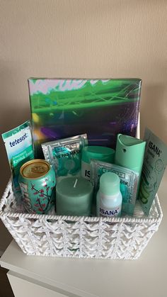 a white basket filled with lots of different types of skin care products on top of a table