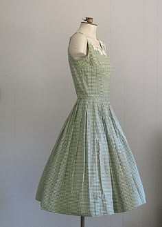 APPROXIMATE MEASUREMENTS (INCHES): Current Size: XS/S Bust: 34 Waist: 24 Hip: OPEN Bodice (shoulder to waist): 15 1/2 Skirt (waist to hem): 25 CONDITION Excellent DESCRIPTION 1950s sundress Fit & flare style Green and white cotton gingham fabric Back metal zip closure No tags; handmade Vintage Sleeveless Plaid Summer Dress, Vintage Sleeveless Spring Plaid Dress, Vintage Sleeveless Plaid Cotton Dress, 1950s Gingham Cotton Dresses, Vintage Gingham Dress For Garden Party, Vintage Sleeveless Plaid Dress, 1950s Plaid Spring Dresses, Vintage Plaid Sleeveless Dress, Fitted Sleeveless Vintage Plaid Dress