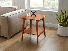 a small wooden table sitting next to a couch