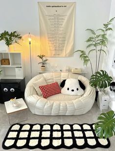 a living room with a white couch and rugs on the floor next to potted plants