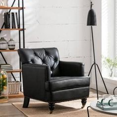 a black leather chair sitting on top of a rug