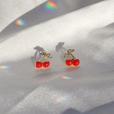 Cherry Stud Earrings | Red Enamel, Pave Crystal, Gold | Cherries - Fruit - Feminist | Wildflower + Co. o. Juicy red cherry stud earrings intricately (& adorably) detailed in enamel, micro pave, & gold. ✳ Materials: dipped in 14k gold, enamel, & tiny pave crystals. Posts are titanium - good for sensitive ears! ✳ Packaged in our cute gift box ✳ Designed by & exclusive to Wildflower + Co. ✳ Imported ✳ Product safety - intended for use by adults only; CA residents - see shop policies for Prop 65 war Cherry Colored Earrings For Valentine's Day Gift, Cherry Color Earrings For Valentine's Day Gift, Cherry Earrings For Valentine's Day Gift, Cherry Colored Earrings Gift, Cherry Colored Round Earrings For Gift, Cherry Round Earrings For Gift, Retro Hypoallergenic Earrings For Gift, Retro Red Dangle Earrings, Nickel Free Cherry Colored Earrings For Gift