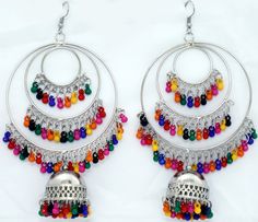 Circular earrings in three steps in silver-tone with multicolor beads inserts. It is a concentric design with a bell that has detailing around it with colorful beads hanging from it. Multicolor Metal Dangle Chandelier Earrings, Multicolor Metal Chandelier Earrings, Multicolor Round Chandelier Earrings For Pierced Ears, Festive Multicolor Chandelier Earrings For Pierced Ears, Multicolor Metal Jewelry With Dangling Beads, Multicolor Metal Earrings For Festivals, Traditional Multicolor Beaded Earrings Nickel Free, Multicolor Metal Festival Earrings, Multicolor Dangle Chandelier Earrings For Festivals