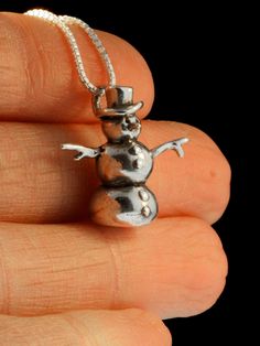 "This solid sterling silver Snowman is guaranteed to melt your heart! He stands 3/4\" high, is completely solid and three dimensional and will stand freely on his own. Wear this whimsical charm throughout the holidays and onto the ski slopes! All Marty Magic Charms and Pendents include an 18 inch (46cm) box chain. If you would prefer a different length of chain please feel free to contact me. All Marty Magic Jewelry is packaged in a beautiful purple box, embossed with the gold foil Marty Magic d Collectible Silver Christmas Jewelry, Christmas Silver Hallmark Jewelry, Silver Hallmark Jewelry For Christmas, Magic Jewelry, Magic Charms, Frosty The Snowman, Jewelry Holiday, Ski Slopes, Frosty The Snowmen