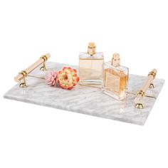 an assortment of perfumes on a marble tray