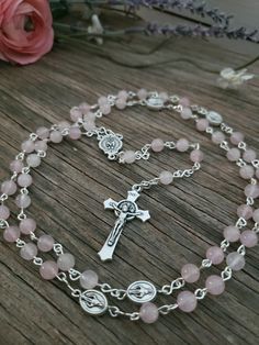 OCTOBER BIRTHSTONE ROSARY - Beautifully made chain link rosary, approximately 20.5" long. Beads are 6mm round Polished (Tourmaline Pink) Rose Quartz Semi-precious Stone, Crucifix is a 1.5" silver finish St. Benedict Cross, and you choose which station beads and centerpiece you would like at checkout! ---Centerpieces options: 1. Holy Spirit / Pray for us 2. St. Michael / Pray for us 3. St. Benedict Medal 4. Guardian Angel / Pray for us 5. Miraculous Mary (1" oval) 6. Fancy Holy Family / Holy Spirit  7. Fancy Miraculous Mary 8. Holy Spirit / Holy Family (oval) 9. Rose / Mary 10. Chalice / Hands ---Stations options: 1. St Benedict 2. FHC Chalice 3. St. Michael / Guardian Angel 4. Miraculous Mary I only purchase American sourced products of the highest quality for my rosaries. That being said, Spiritual Pink Jewelry For Birthday, St Benedict Cross, Mary 1, Rose Mary, Benedict Medal, St Benedict, Catholic Rosary, Pink Rose Quartz, Rosary Catholic