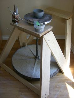 a small wooden table with two plates on it