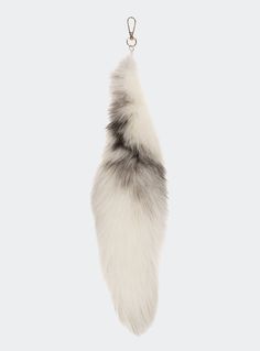 a keychain with a furry animal tail hanging from it's side