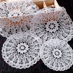 two boxes with doily on top of them