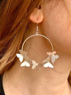 Make a statement with our bold Butterfly Hoop Earrings. These stylish dangling hoops feature a beautiful multiple butterfly design. Elevate your look with these eye-catching earrings. Size: 1.5" hoop Butterfly: 0.5" x 0.75" Spring Small Hoop Earrings, Spring Small Hoop Earrings For Pierced Ears, Modern Summer Hoop Earrings, Trendy Spring Dangle Hoop Earrings, Spring Trendy Dangle Hoop Earrings, Trendy Dangle Hoop Earrings For Spring, Elegant Spring Butterfly Jewelry, Silver Drop Earrings For Spring, Spring Sterling Silver Earrings