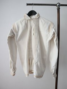 C1930s Transylvanian folk blouse. Acquired from my travels in the Carpathian Mountains.  Homespun linen. Really lovely pleated bib up the front. White glass buttons. Trapeze shape with balloon sleeves. Very small cutout or open weave sections around the collar, across the shoulders, cuffs and hem. The embroidery on these areas is in a peachy colour. Gathered pleats at the back of the neck, on the shoulders, base of the front panels and cuffs. Crochet trim at the hem. There are embroidered motif Henry Darger, Cropped Linen Trousers, Carpathian Mountains, Eastern European, Open Weave, Linen Trousers, Glass Buttons, Crochet Trim, Blouse Shirt