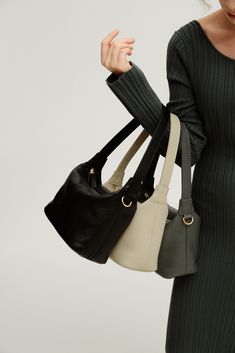 Minimalist Black Textured Leather Bag, Eco-friendly Shoulder Bag With Leather Handles For Everyday Use, Eco-friendly Black Shoulder Bag For Shopping, Eco-friendly Black Bags With Leather Handles, Eco-friendly Black Shoulder Bag With Removable Pouch, Sustainable Leather, S Signature, Signature Look, Small Accessories