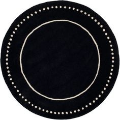 a black rug with white dots on the center and an oval design in the middle