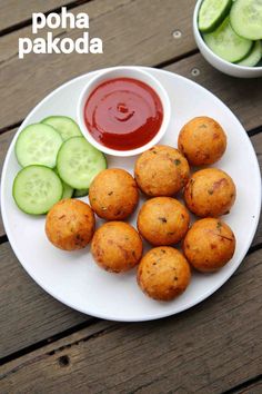 some food on a white plate with cucumbers and ketchup next to it