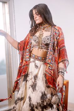 Multi colored dupatta style jacket with collage print in sheer silk base with embroidered and tribal tassel detail on neck and hem.
Component: 1
Pattern: Printed, Embroidered
Type Of Work: Floral and Geometric Motifs
Neckline: Front Open
Fabric: Sheer Silk
Color: Multi Color
Other Details: 
Tassel details
Note: The corset, tunic, skirt and jewellery, bag shown in the image is not for sale
Occasion: Puja
Disclaimer: Variations in colour and the positioning of artwork may be different from that as Designer Multicolor Tassel Dupatta, Bohemian Silk Set With Sheer Dupatta, Bollywood Choli With Tassels, Bohemian Silk Sets With Resham Embroidery, Festive Bohemian Chanderi Sets, Multicolor Anarkali Dupatta With Tassels, Bohemian Designer Lehenga With Printed Motifs, Festive Multicolor Kurta With Tassels, Bollywood Style Festive Kurta With Back Tassel Tie-up