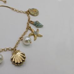 This beautiful gold toned charm bracelet was the lost treasure of a mermaid princess which was found recently at the bottom of the sea. It's told to possess magical properties and brings luck and prosperity to the wearer. The bracelet measures 7" long and includes a 3" adjustable slider chain. It features many sea life charms, including a seahorse, starfish and shells with pearls. Your treasure will be carefully packaged in a box ready for gifting, AND include a special backstory. Lost Treasure, Bottom Of The Sea, Mermaid Jewelry, Mermaid Princess, Hair Accessories Jewelry, Fantasy Jewelry, A Mermaid, Sea Life, Ring Necklace