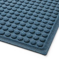 a blue bath mat with circles on the bottom and one circle in the middle, is shown