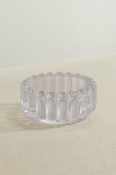 a clear glass bowl sitting on top of a table