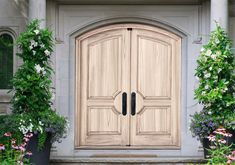 a large wooden door sitting in the middle of a garden