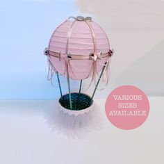 a pink paper lantern sitting on top of a table