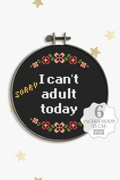 a cross stitch hoop with the words i can't adult today on it and stars around