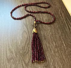 Handmade, Burgundy natural Garnet mala necklace, gold accents. One-of-a-kind jewelry. Yoga jewelry. Bohemian necklace, antique look. The necklace is accented with a focal gold fill bead and flower bead that holds a beautiful cascade of stones in the tassel. This one of a kind Mala necklace is 29 inches long. Tassel is about 5 inches long. It's absolutely gorgeous and the photos cannot show the true beauty of this piece. This unique necklace was Inspired by my love to Yoga, particularly Kundalini Gold Hand-knotted Necklace For Gift, Gold Hand Knotted Necklace For Gift, Elegant Hand Knotted Beaded Necklaces For Gifts, Elegant Hand-knotted Beaded Necklaces For Gifts, Elegant Hand Knotted Beaded Necklace Gift, Elegant Red Necklace With Latkans, Elegant Latkans Necklace As A Gift, Elegant Festive Hand-strung Beaded Necklaces, Necklace Antique