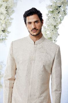 This sherwani set features all over matt sequin on a sand raw silk base. It is paired with off-white silk kurta and soften raw silk afghani salwar. Complimenting stole and footwear is also available.From Seema Gujral's Tuscan Summer collection. DELIVERY TIMEPlease allow 8-12 weeks for your outfit to arrive.FABRIC DETAILSRaw SilkProfessional cleaning only. Beige Raw Silk Sherwani With Dabka, Unstitched Beige Sherwani With Naqshi Detailing, Beige Sherwani With Resham Embroidery For Transitional Season, Beige Raw Silk Sherwani With Zari Work, Traditional Beige Raw Silk Sherwani, Unstitched Beige Sherwani With Zari Work, Traditional Off White Raw Silk Bandhgala, Festive Off-white Raw Silk Sherwani, Cream Bandhgala With Chikankari Embroidery For Transitional Season