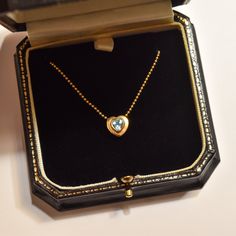 A lovely Italian 18k aquamarine heart pendant necklace. A great gift for a loved one this holiday season. Features a heart-shaped aquamarine stone bezel set in a solid gold heart pendant suspended from a ball chain necklace. The pendant is strung through two whole in the top of the heart and the necklace secures with a standard spring-ring clasp.  The necklace is hallmarked '750' on a metal tag attached to the clasp and the gold has been acid tested for authenticity. We believe the stone is most Fine Jewelry Heart Necklace With Birthstone For Formal Occasions, Luxury Aquamarine Necklace For Anniversary, Heart-shaped Bezel Setting Necklaces For Gifts, Yellow Gold Gemstone Heart Necklace For Anniversary, Anniversary Yellow Gold Heart Necklace With Gemstone, Fine Jewelry Aquamarine Necklace As Gift, Hallmarked Blue Topaz Necklaces For Anniversary, Hallmarked Blue Topaz Necklace For Anniversary, Valentine's Day Gift Necklaces With Bezel Setting