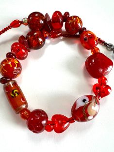 Vintage Murano red and orange glass beads are in different shape and size, there are two heart shape glass beads ,  hand-painted glass, glass with foil. The whole necklace is make of glasses strung on black wire, finished with toggle clasp. There is no two beads look the same as they are all handmade. Very romantic handmade vintage jewellery, gift for her. In great vintage condition with  small wear. Especially on the clasp. Send from France. Everything I share here is vintage, it means they are old and original and can have signs of age. That's the beauty of it ( in my eyes). But I will let you know any notable features or damage. Feel free to contact me with any questions :) Thank you for visiting and enjoy your shopping!  Chez Echo Vintage  https://chezechovintage.etsy.com Bohemian Red Heart-shaped Bracelet, Glass Heart Beads Necklaces, Red Czech Glass Bracelets With Colorful Beads, Glass Heart Bead Necklace, Glass Heart Beads Necklace, Red Bohemian Beaded Bracelets With Heart Beads, Bohemian Red Beaded Bracelets With Heart Beads, Red Heart Beads For Gifts, Red Heart-shaped Hand Painted Jewelry