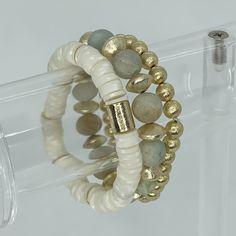 This bracelet stack is the perfect neutral transitions stack perfect for all year long. Each of these three bracelets can be worn by itself or paired with other Designs by KB bracelets for the perfect art party! In this stack: -One 8mm Snow Dot Heishi bracelet with gold accents -One 10mm Calypso Grande bracelet with brushed gold saucers -One 8mm Goddess bracelet Gold Multi-strand Stackable Beaded Bracelets, Adjustable Stackable Beaded Bracelets For Layering, Gold Multi-strand Stackable Bracelets, Stackable Wrap Bracelet For Layering, Stackable Round Bracelets, White Bohemian Stacked Bracelets, Bohemian White Stacked Bracelets, Adjustable Stacked Gold Beaded Bracelets, Adjustable Gold Stacked Beaded Bracelets