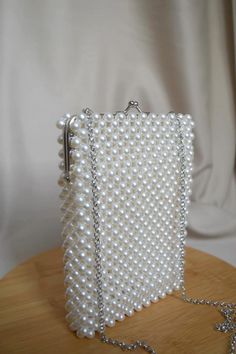 You can find our bags on Etsy.com White Bags With Pearl Chain, White Pearl Bag With Pearl Chain, Elegant White Bags With Pearl Chain, White Rectangular Clutch With Pearl Embroidery, White Pearl Bag For Events, White Evening Bag With Pearl Chain, Rectangular Evening Bag With Pearl Embroidery, Handmade Pearl Evening Bag For Events, White Pearl Clutch For Events