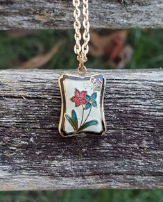 "This is a vintage, cloisonne pendant with flowers and a butterfly. It has the image on both sides. *I added a gold colored necklace on here. Please let me know what length you want it to be. This would be a great gift for an anniversary, wedding, Christmas, birthday, or any other occasion. Size: 5/8\" tall Condition: Very good Maker's Mark: None This model is retired and is no longer in production. All jewelry items come in a gift box." Vintage Gold Jewelry With Birth Flower Detail, Vintage Gold Jewelry With Birth Flower, Vintage Birth Flower Necklaces For Jewelry Making, Vintage Enamel Jewelry With Rectangular Shape, Vintage Rectangular Enamel Jewelry, Vintage Birth Flower Pendant Jewelry, Vintage Flower Jewelry Keepsake, Vintage Enamel Flower Pendant Jewelry, Vintage Birth Flower Pendant Necklace