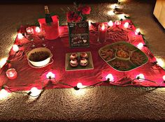 a table topped with lots of food and candles