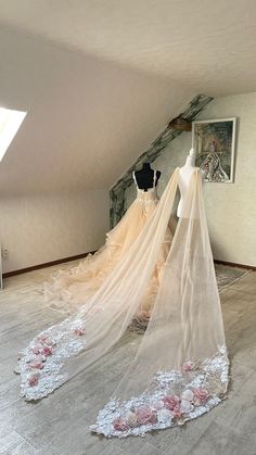 two mannequins dressed up in wedding gowns and veils