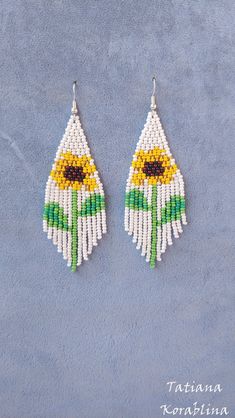 "These handmade unique earrings \"Sunflower\" are made of high-quality Czech beads and strong synthetic thread. I use my author's scheme . They are elegant, fashionable, and highly versatile, suitable for everyday wear. Color: white,yellow,brown,green . Copy without my permission is prohibited For those who want to buy my copyright scheme for these earrings: https://www.etsy.com/uk/listing/1056785837/brick-stitch-pattern-for-seed-bead?ref=shop_home_active_2 100% hand made with love! Measurements Bohemian Sunflower Design Jewelry With Round Beads, Bohemian Summer Jewelry With Sunflower Design, Summer White Flower Earrings With Colorful Beads, Bohemian Sunflower Design Jewelry For Summer, Bohemian Sunflower Design Summer Jewelry, Summer Beaded Dangle Flower Earrings, Bohemian Sunflower Drop Earrings, Sunflower Dangle Earrings For Summer, White Flower Drop Earrings For Summer