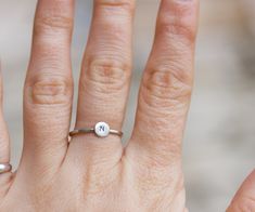 This refined initial ring is made of sterling silver and bears your's dearest initial. The outside surface may be raw and matte or shiny and polished - just state it in the message to the seller during the check-out. This ring ideally passes any style and outfit. The ring is 1 mm thick and is very sturdy although it looks very dainty on the finger. You may order just one ring or few of them - they are stackable and look pretty good together. Each letter on the ring is hand stamped and gives a fe Simple Personalized Initial Ring For Everyday, Minimalist Stackable Initial Ring For Promise, Minimalist Stackable Initial Promise Ring, Personalized Dainty Initial Ring, Dainty Personalized Initial Ring With Round Band, Adjustable Initials Stackable Rings For Everyday, Everyday Adjustable Stackable Rings With Initials, Simple Stackable Initial Ring, Simple Stackable Initial Ring For Everyday