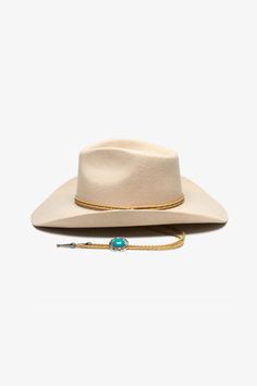 Australian wool cowboy style hat from Wyeth! Featured in a timeless, seasonal bone color with leather bolo tie trim and medallion. Material: 100% Australian wool Sizing: brim size = 3.75", crown size = 4.5", medallion = 1.25" Western Style Gold Fedora With Flat Brim, Western Gold Fedora With Short Brim, Western Style Gold Fedora With Short Brim, Classic Adjustable Hat Bands For Western-themed Events, Western Cream Felt Hat With Flat Brim, Classic Cream Fedora For Rodeo, Adjustable Western Bolo Ties For Rodeo, Classic Gold Flat Brim Hat Band, Western Cream Fedora Felt Hat