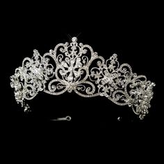 a tiara with crystal stones and pearls on the headpiece is shown against a black background