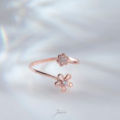 With this dainty Original 925 Silver Shining Korean Style Minimalist Flower Ring look as beautiful outside as you are within. this elegantly crafted 925 Sterling Silver Floral Ring is perfect for everyday wear. This Dainty Two Flower Stackable Ring is crafted with love and care for elegant moments of yours. Invest in your beauty, invest in Jewelry. These Handmade Adjustable Band rings are perfect for everyday wear and a perfect gift for birthdays, Christmas, or best friends. PRODUCT DETAILS The material is Solid 925 Sterling Silver. 14K Gold and rose gold are plated over solid 925 sterling silver. ❤ The Ring comes in a special gift box All jewelry of LeianArt is hand-made. 🎁 All Your LeianArt jewelers are nicely packaged and ready to gift in an elegant box. Ready for gift-giving. ️Please Delicate Rose Gold Flower Ring, Rose Gold Flower Ring For Promise, Rose Gold Flower Promise Ring, Delicate Rose Gold Flower-shaped Ring, Delicate Rose Gold Flower Shaped Ring, Rose Gold Sterling Silver Flower Rings, Delicate Flower Shaped Promise Ring, Fine Jewelry Flower Promise Ring, Dainty Blossom-colored Jewelry For Anniversary