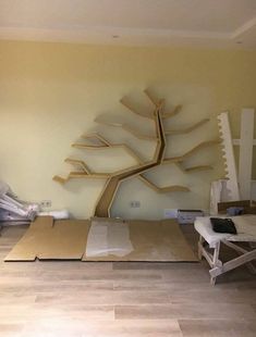 a room that has some kind of tree on the wall in it, and is being constructed