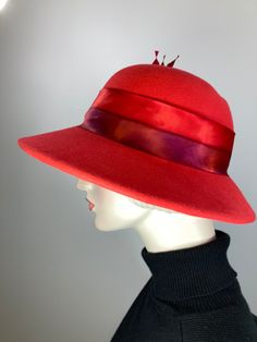 This hat would be right at home on Downton Abbey! The color is a bright red. It is topped with a hand dyed silk band that matches perfectly! Embellished with tree handmade silk roses and hand cut feathers. The brim shape is a soft oval and the sides are longer than the front; the back is much narrower at 2 1/4 inches. It is hand blocked using traditional millinery techniques, including steaming, shaping, and hand sewing. ++++++++++++++++++++++++++++++++++++++++++++++++++++++FIT AND SIZE:The inne Womens Winter Hats, London In March, Downton Abbey Style, Downton Abbey Fashion, Hat Felt, Warm Winter Hat, Tree Handmade, Warm Winter Hats, Dyed Silk