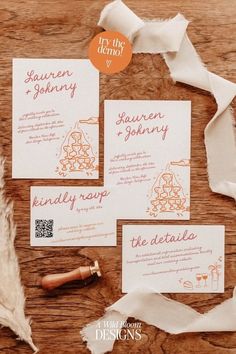 the wedding stationery is laid out on top of some white paper with orange ink