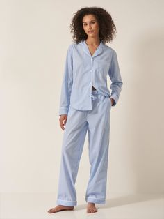 Designed to feel both classic and contemporary, and cut for a relaxed yet tailored fit, this Blue & White Stripe 100% organic GOTS certified cotton pyjama set will brighten your nights and mornings with its vibrant all-over print. With contrast piped trims throughout, the bottoms come with handy slip pockets at sides and a drawstring elasticated waistband with fabric self-tie. If you like your pjs cut a little more generously we recommend going up a size. 100% organic GOTS certified cotton Contr Relaxed Fit Cotton Sets With Long Pants, Relaxed Fit Cotton Set With Long Pants, Cotton Sets With Relaxed Fit Long Pants, Classic Cotton Sleepwear For Pajama Party, Classic Relaxed Fit Loungewear Sets, Classic Cotton Long Sleeve Sleepwear, Classic Cotton Loungewear Set, Classic Cotton Sleepwear With Long Sleeves, Classic Relaxed Fit Pajama Party Sets